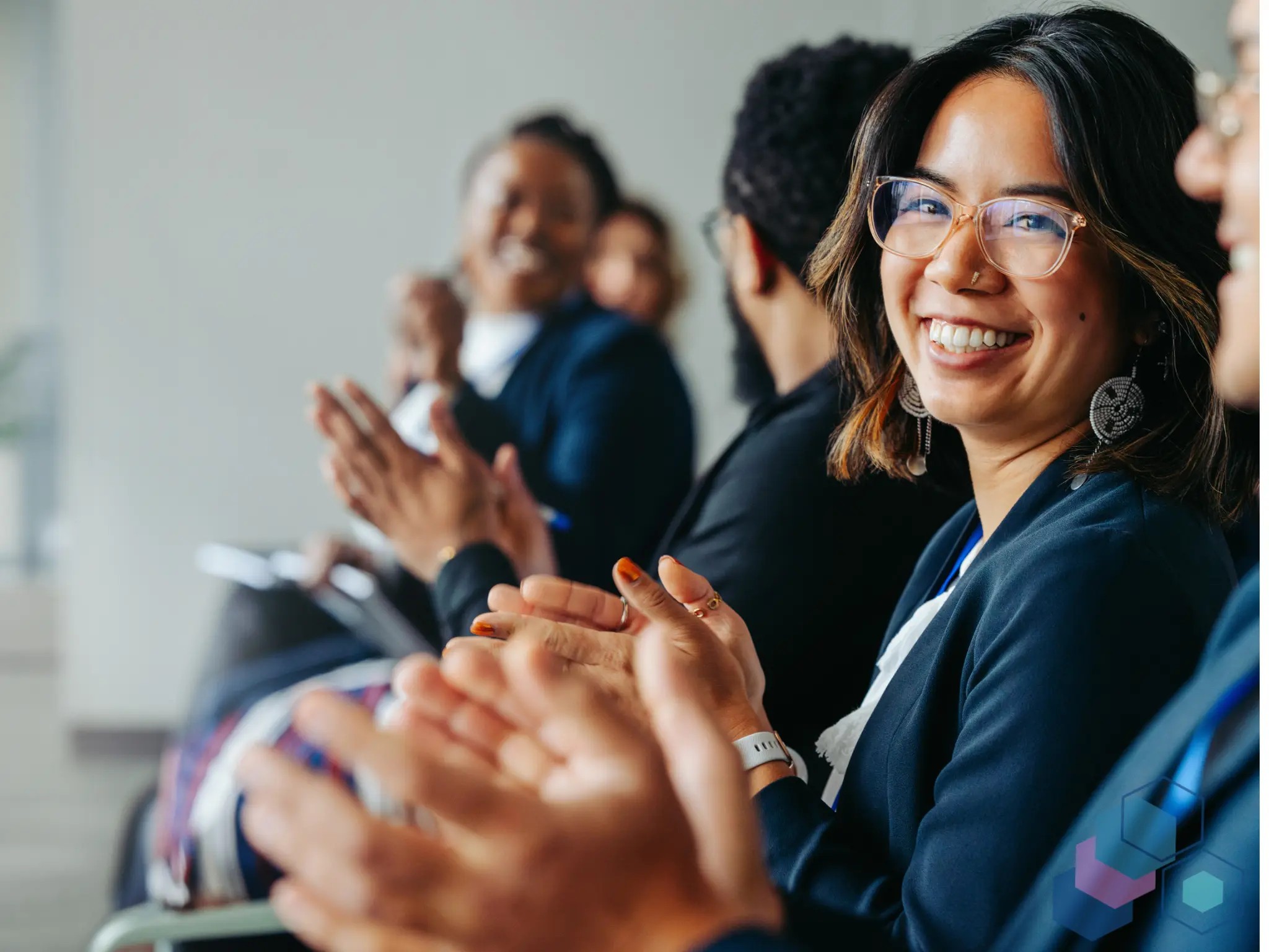 Engaged diverse audience applauding at a professional leadership event